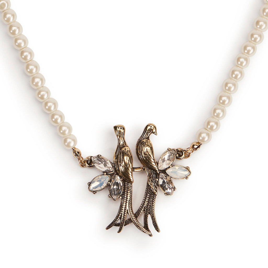 Close up detail of Love Birds Charm sitting on Pearl Choker strand